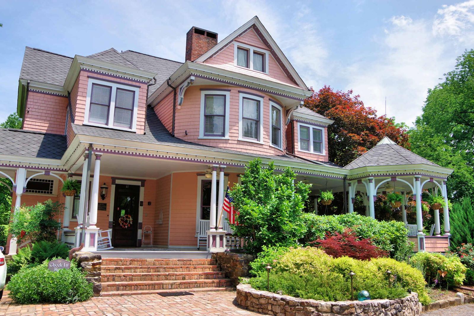 Beaufort House Inn, a salmon pink Queen Anne Victorian with a wraparound porch in Asheville, NC