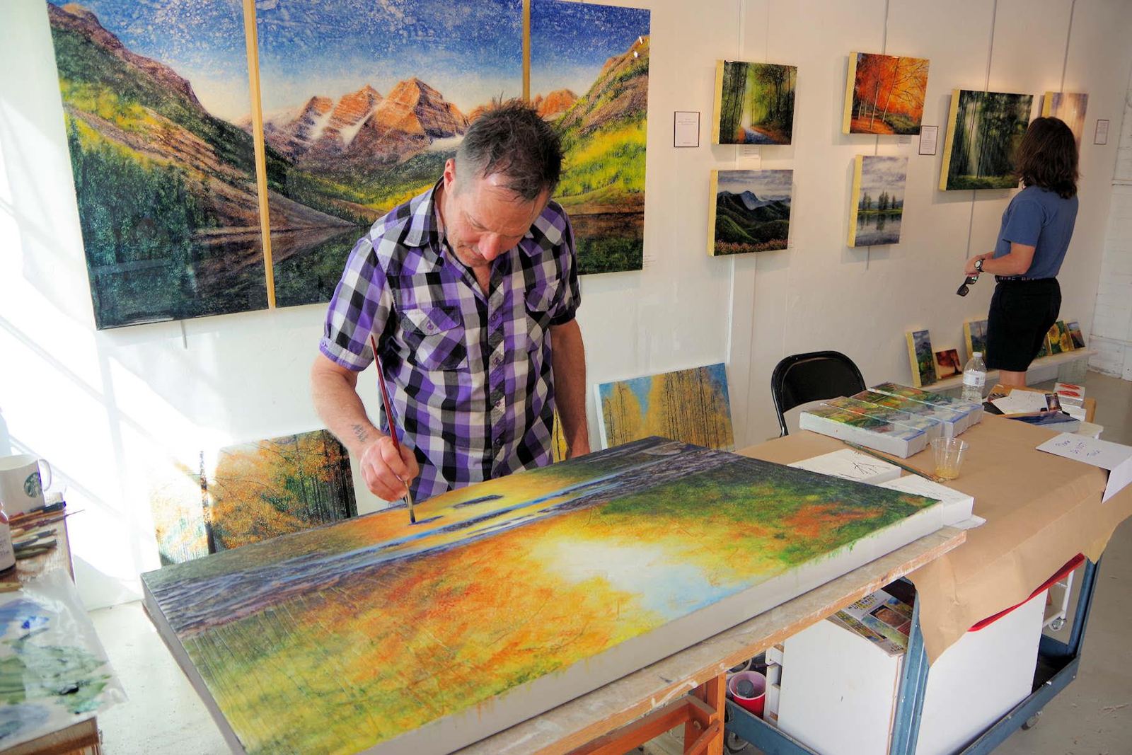An artist painting in a River Arts District studio in Asheville